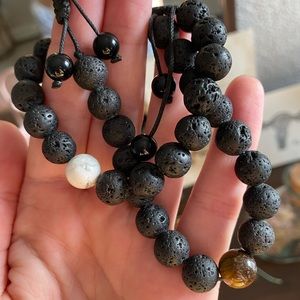 Set of two essential oil lava rock bracelets one with tiger eye stone